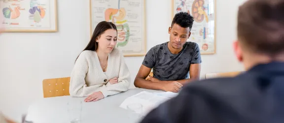 Lernende am Tisch während der Erweiterten Pflegehelferausbildung Nürnberg