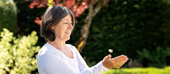 Frau lässte einen Schmetterling fliegen